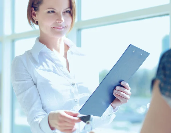 A young women sitting near window with folder — Stock Photo, Image