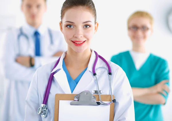 Woman doctor standing with folder at hospital — Stock Photo, Image