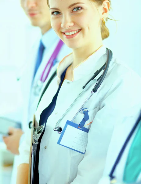 Attractive female doctor  with folder in front of medical group — Stock Photo, Image