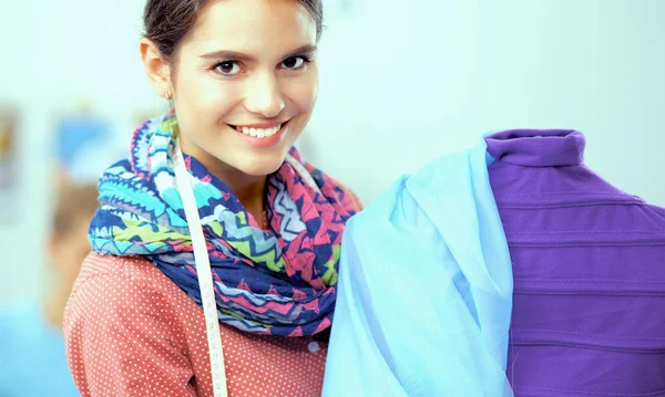 Smiling fashion designer standing near mannequin in office — Stock Photo, Image