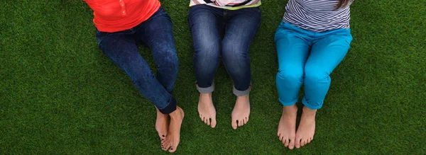 Jeunes femmes assises sur l'herbe verte — Photo