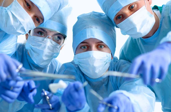 Below view of surgeons holding medical instruments in hands — Stock Photo, Image