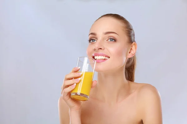 Cheerful smiling girl with towel holding a glass of orange juice — Stock Photo, Image