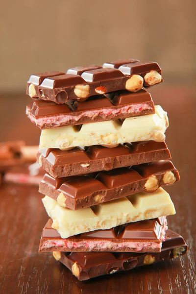 Mix of chocolate pieces on table, close-up — Stock Photo, Image