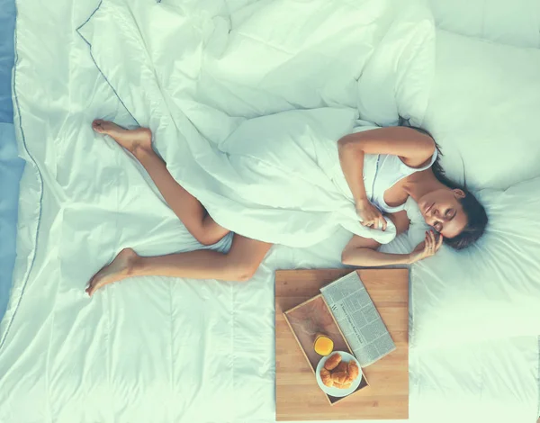 Young beautiful woman lying in bed at home — Stock Photo, Image