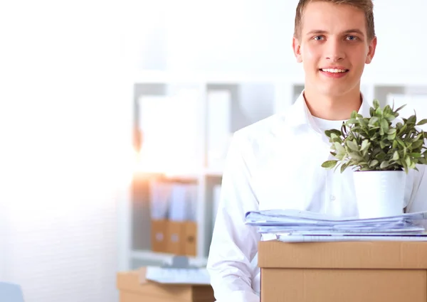 Portrait of a person with moving box and other stuff isolated on white — Stock Photo, Image