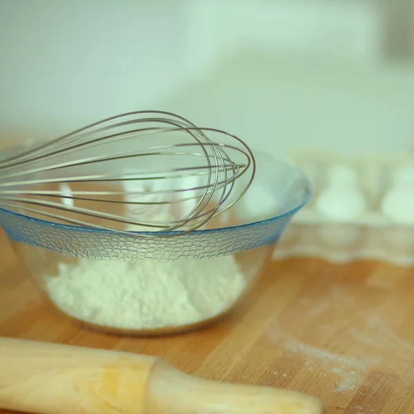 Flour with eggs, ricotta cheese and rolling pin at the desk — Stock Photo, Image