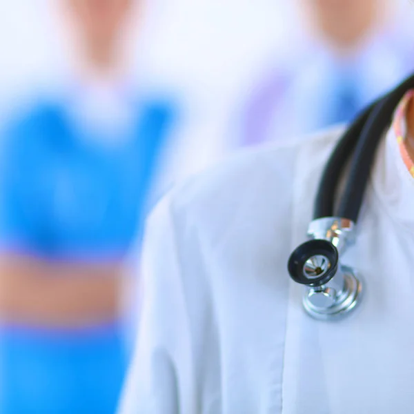 Attractive female doctor in front of medical group — Stock Photo, Image