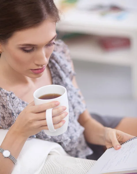 Attractive businesswoman sitting  on desk in the office — Stock Photo, Image