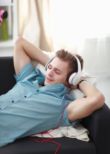 Homem ouvindo música com fones de ouvido em casa — Fotografia de Stock