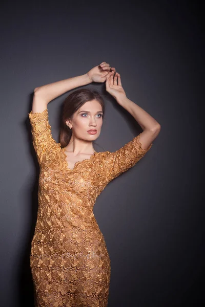 Attractive woman in gold dress — Stock Photo, Image