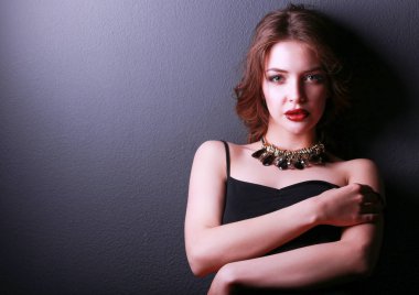 Siyah elbiseli, akşam makyajlı güzel bir kadın.