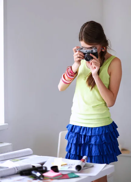 Retrato de una joven fotógrafa hermosa cerca de la mesa —  Fotos de Stock