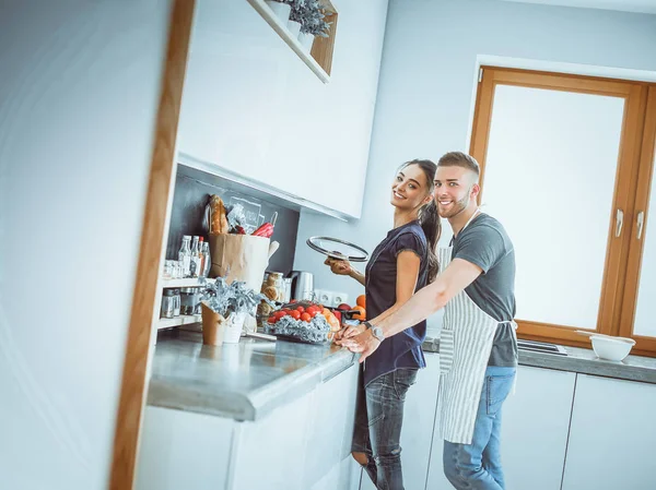 Bir çift evdeki mutfaklarında birlikte yemek pişiriyor. — Stok fotoğraf