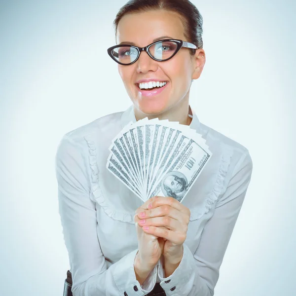 Een jonge vrouw met dollars in haar handen, geïsoleerd op witte achtergrond — Stockfoto