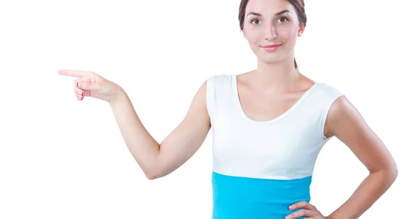 Portrait of a smiling young woman pointing up — Stock Photo, Image