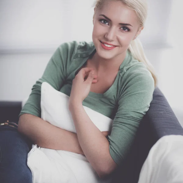 Young beautiful woman sitting on couch at her room — Stock Photo, Image