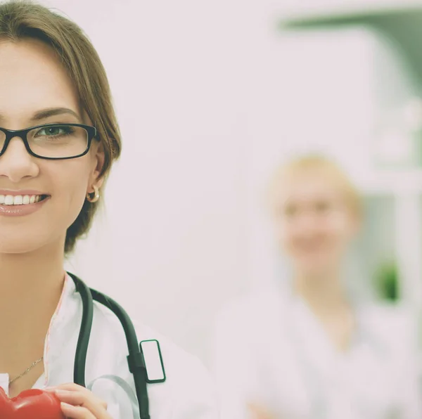 Doctor with stethoscope holding heart, isolated on white  background — Stock Photo, Image