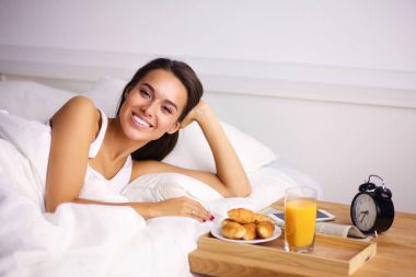 Evde yatakta yatan genç güzel kadın