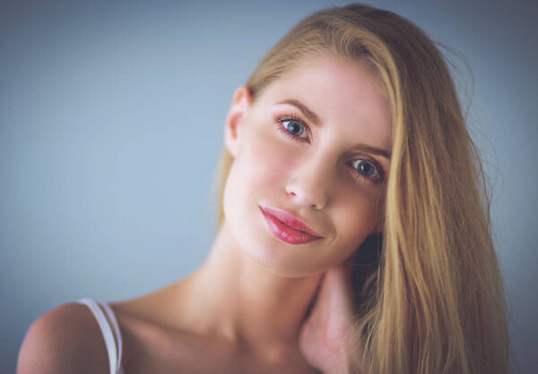 Portrait of beautiful woman isolated on gray background