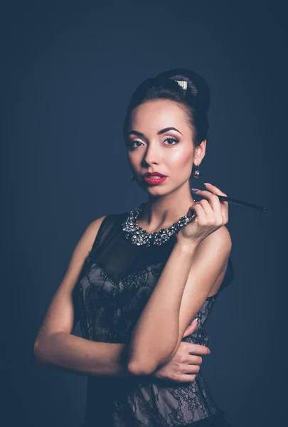 Retro woman portrait, standing on the black background — Stock Photo, Image