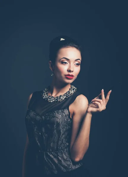 Retro woman portrait, standing on the black background — Stock Photo, Image