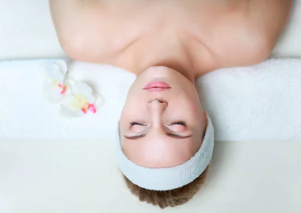 Beautiful young woman getting spa massage, lying on salon — Stock Photo, Image