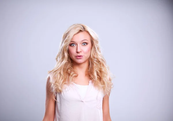 Young emotional woman, isolated on gray background — Stock Photo, Image