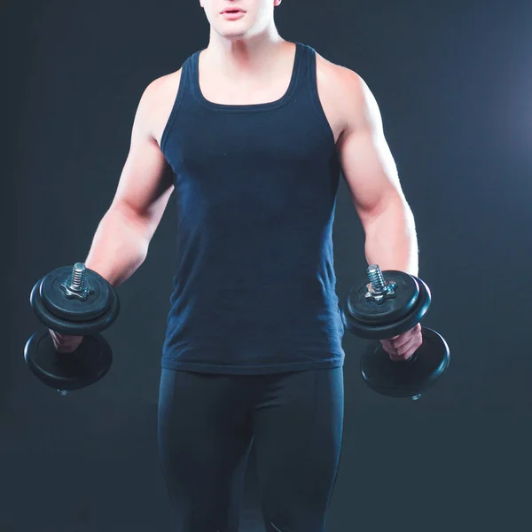 Handsome muscular man working out with dumbbells — Stock Photo, Image