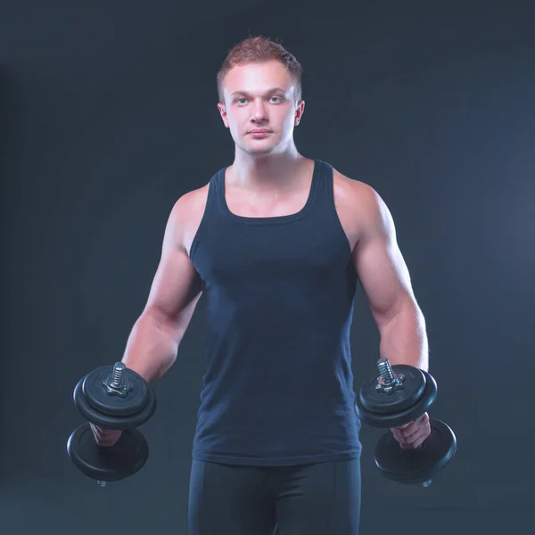 Handsome muscular man working out with dumbbells — Stock Photo, Image