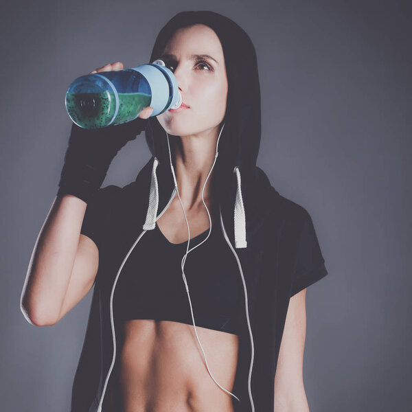 Girl with bottle in hands after sport