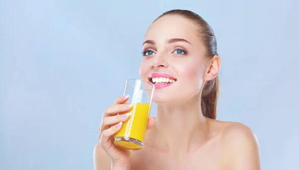 Cheerful smiling girl with towel holding a glass of orange juice — Stock Photo, Image