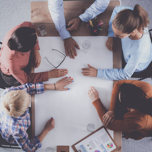 Business people sitting and discussing at business meeting, in office