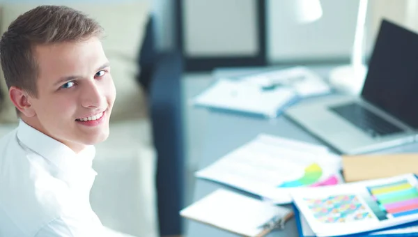 Young businessman working in office, standing near desk — Stock Photo, Image