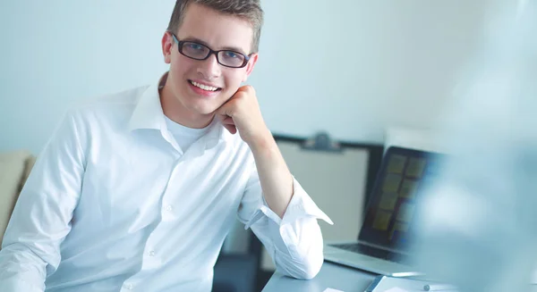 Young businessman working in office, standing near desk — Stock Photo, Image