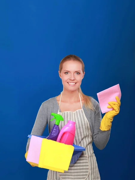 Cheerful woman is cleaning something with wisp and spray attentively. — Stock Photo, Image