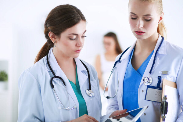 Young woman doctor holding a tablet pc