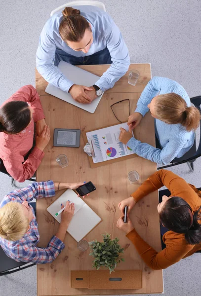 Business people sitting and discussing at meeting, in office — Stock Photo, Image