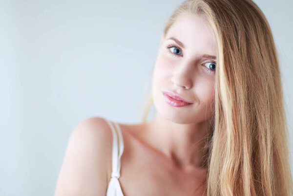 Portrait of beautiful woman isolated on gray background