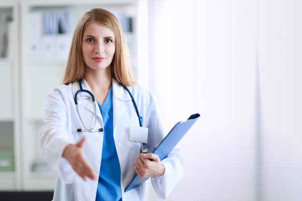 Doctor woman is standing in the near window