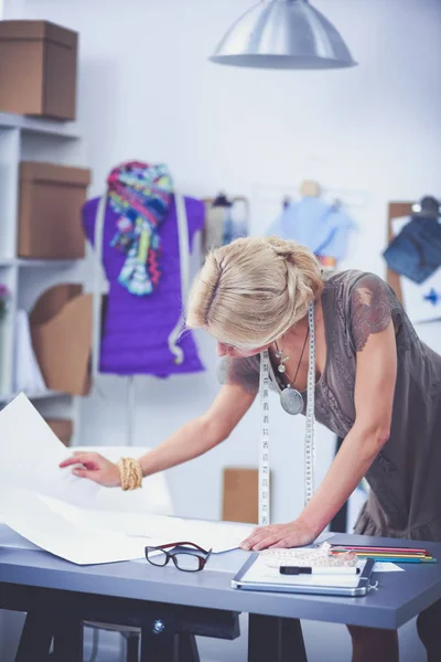 Junge Modedesignerin arbeitet im Atelier. — Stockfoto