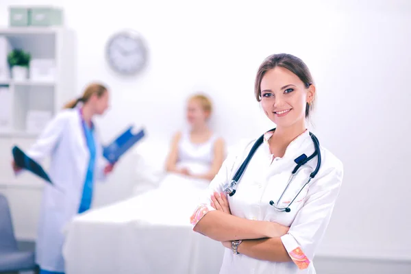 Woman doctor standing at hospital with medical stethoscope — Stock Photo, Image