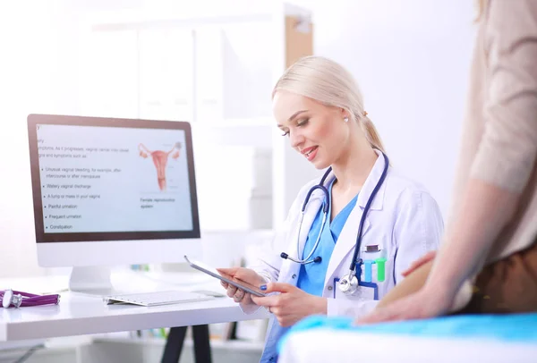 Arzt und Patient diskutieren etwas, während sie am Tisch sitzen. Medizin und Gesundheitswesen. Arzt und Patient — Stockfoto