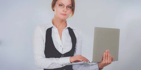 Unga vackra kvinnan visar en laptop, isolerad på vit bakgrund — Stockfoto