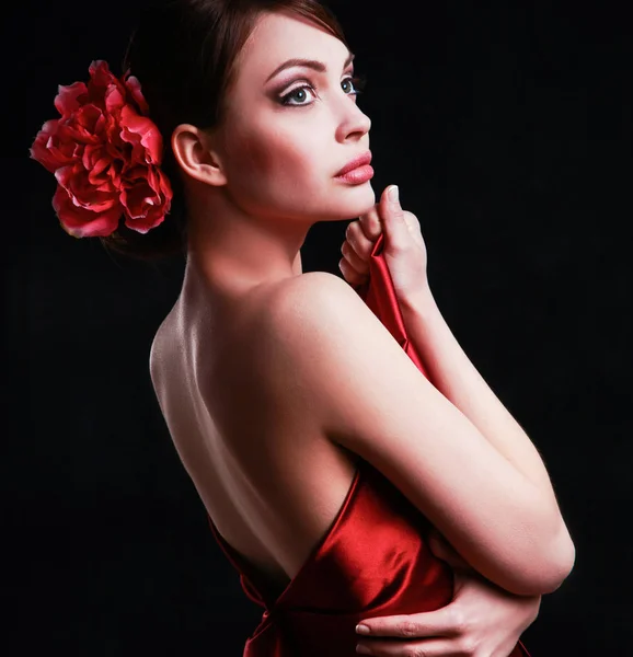 Young woman in red dress, isolated on black background — Stock Photo, Image