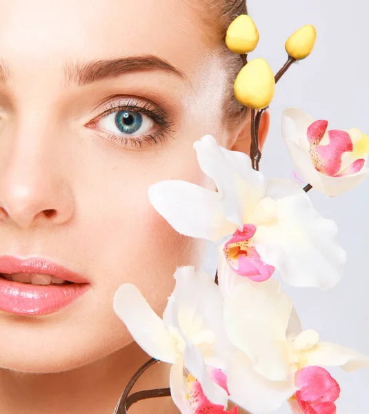 Young woman with orchid, isolated on white background — Stock Photo, Image