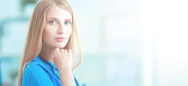 La doctora está parada en la ventana cercana. — Foto de Stock