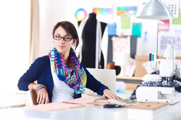 Young dressmaker designing clothes pattern on paper . — Stock Photo, Image