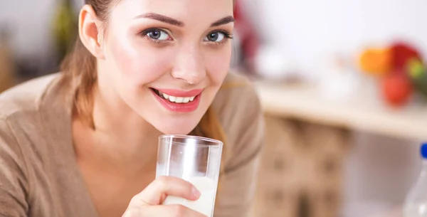 Smiling attractive woman having breakfast in kitchen interior — Stock Photo, Image