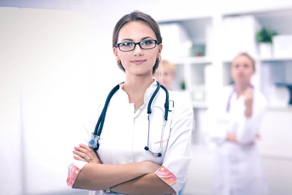 Young woman doctor standing at hospital with medical stethoscope — Stock Photo, Image